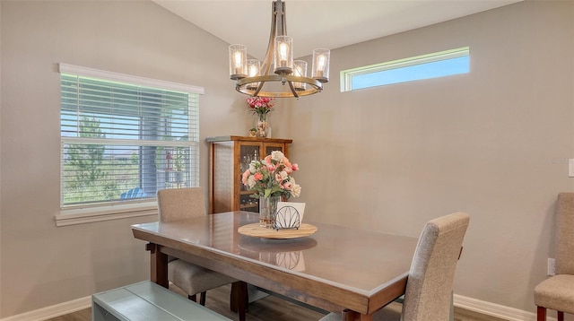 6435 165th Dr E, Parrish, FL 34219 - dining area featuring a chandelier, wood finished floors, and lofted ceiling