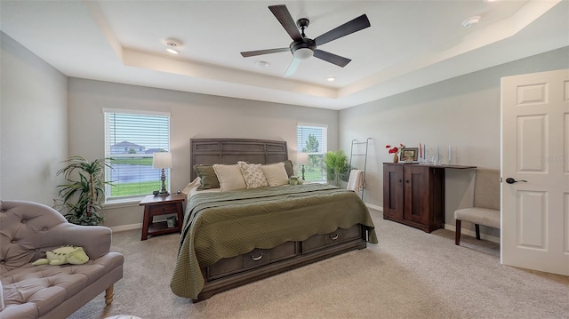 6435 165th Dr E, Parrish, FL 34219 - bedroom featuring a tray ceiling, light carpet, and a ceiling fan