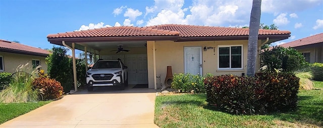 3305 Notre Dame Pl Unit 3305, Bradenton, FL 34207 - view of front of house featuring driveway, a tile roof, stucco siding, and a carport