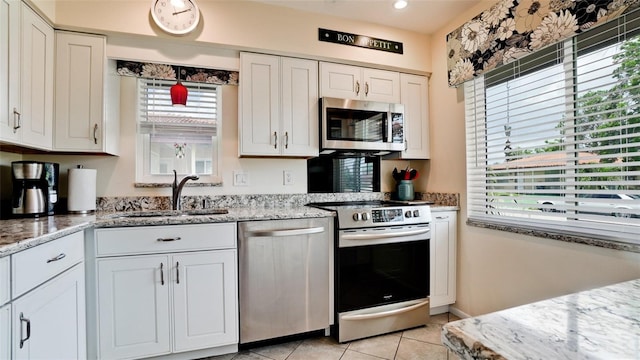 3305 Notre Dame Pl Unit 3305, Bradenton, FL 34207 - kitchen with stainless steel appliances, plenty of natural light, and white cabinetry