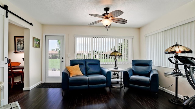 3305 Notre Dame Pl Unit 3305, Bradenton, FL 34207 - living area featuring a barn door, hardwood / wood-style flooring, ceiling fan, and a textured ceiling
