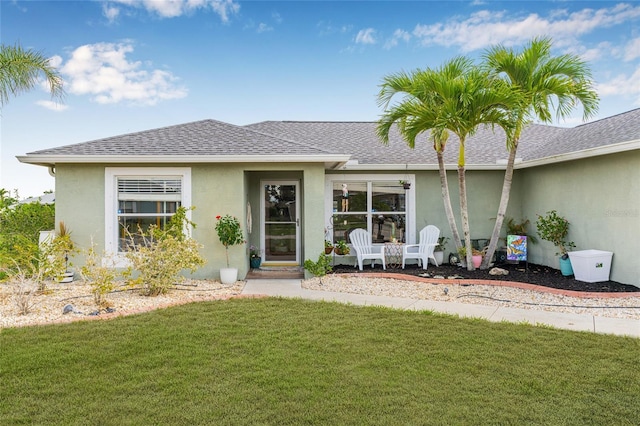 6178 Coliseum Blvd, Port Charlotte, FL 33981 - view of front of property featuring stucco siding, a front lawn, and roof with shingles
