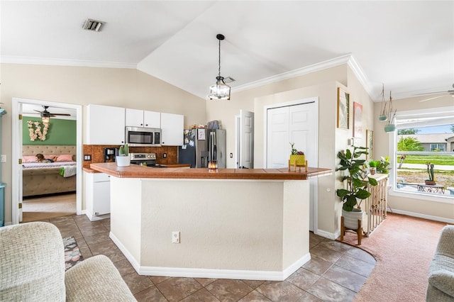 6178 Coliseum Blvd, Port Charlotte, FL 33981 - kitchen with stainless steel appliances, ceiling fan, ornamental molding, white cabinetry, and pendant lighting