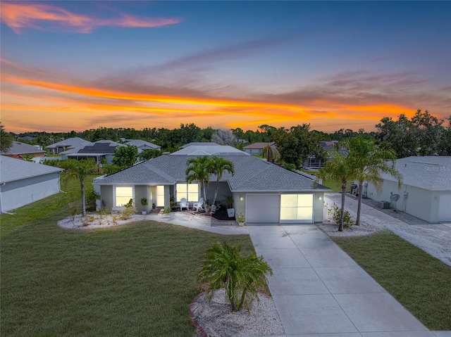 6178 Coliseum Blvd, Port Charlotte, FL 33981 - single story home featuring a yard, an attached garage, driveway, and roof with shingles