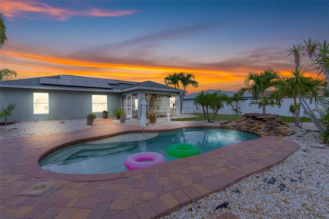 6178 Coliseum Blvd, Port Charlotte, FL 33981 - pool at dusk featuring a patio area and a fenced backyard