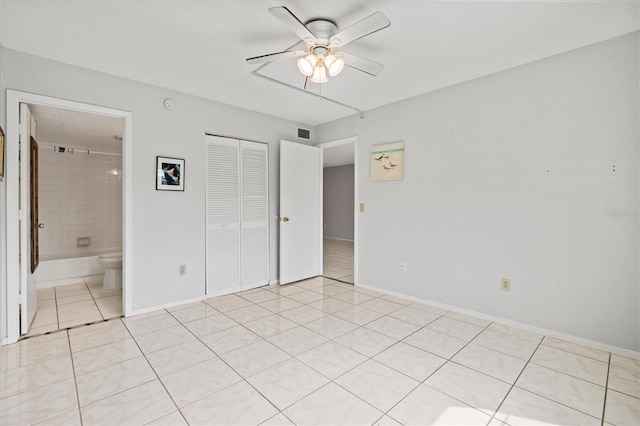 25100 Sandhill Blvd Unit 104G, Punta Gorda, FL 33983 - unfurnished bedroom with light tile patterned flooring, a closet, ensuite bathroom, and ceiling fan