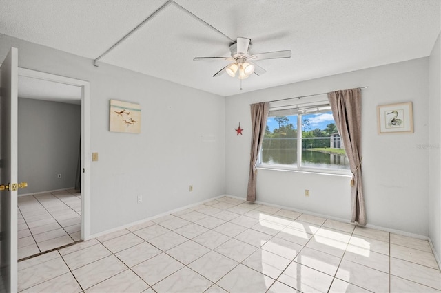 25100 Sandhill Blvd Unit 104G, Punta Gorda, FL 33983 - empty room featuring ceiling fan, light tile patterned floors, and a water view