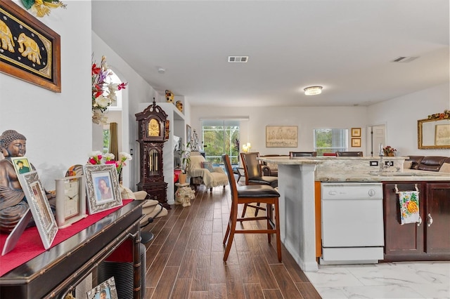 25324 Alicante Dr, Punta Gorda, FL 33955 - kitchen with dishwasher, open floor plan, light stone countertops, and a breakfast bar