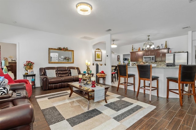 25324 Alicante Dr, Punta Gorda, FL 33955 - living area featuring dark wood-style flooring and arched walkways