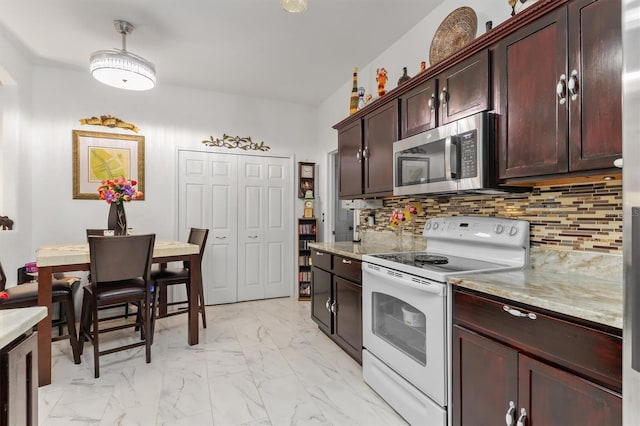 25324 Alicante Dr, Punta Gorda, FL 33955 - kitchen featuring white range with electric stovetop, stainless steel microwave, light marble finish floors, tasteful backsplash, and light stone counters