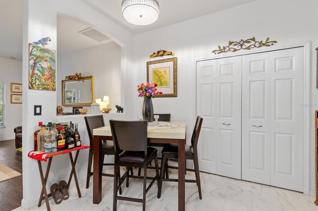 25324 Alicante Dr, Punta Gorda, FL 33955 - dining area with arched walkways and light marble finish floors