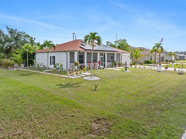 25324 Alicante Dr, Punta Gorda, FL 33955 - back of property with an attached garage, solar panels, and a lawn