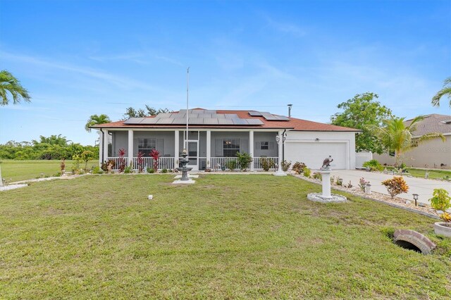 25324 Alicante Dr, Punta Gorda, FL 33955 - ranch-style house with a garage, solar panels, a front yard, driveway, and a sunroom