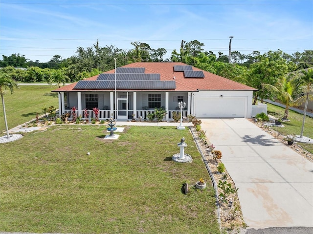 25324 Alicante Dr, Punta Gorda, FL 33955 - view of front of home featuring covered porch, an attached garage, a front lawn, concrete driveway, and roof mounted solar panels