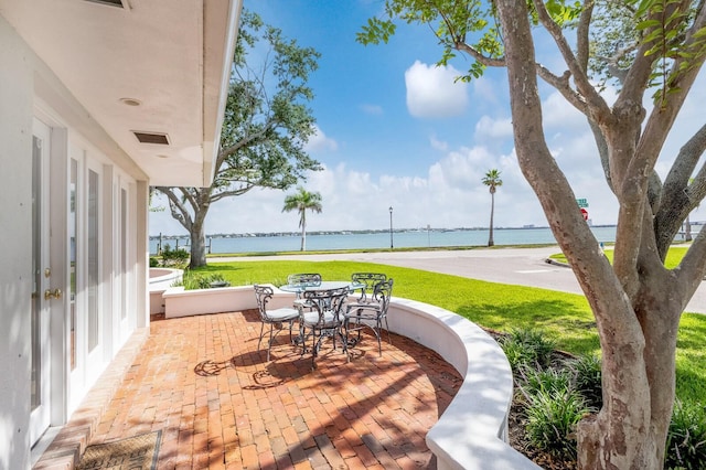 2401 Riverview Blvd, Bradenton, FL 34205 - view of patio featuring outdoor dining space and a water view