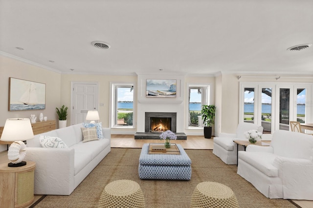 2401 Riverview Blvd, Bradenton, FL 34205 - living area with ornamental molding, a lit fireplace, and wood finished floors