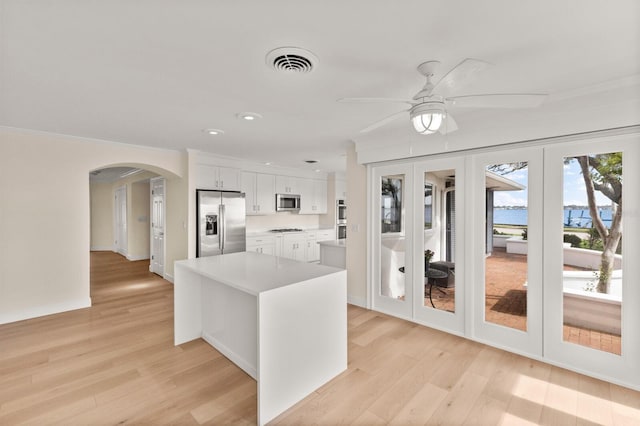 2401 Riverview Blvd, Bradenton, FL 34205 - kitchen featuring appliances with stainless steel finishes, arched walkways, french doors, light countertops, and a ceiling fan