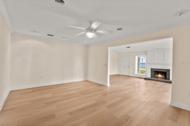 2401 Riverview Blvd, Bradenton, FL 34205 - unfurnished living room featuring crown molding, light wood finished floors, ceiling fan, and a fireplace