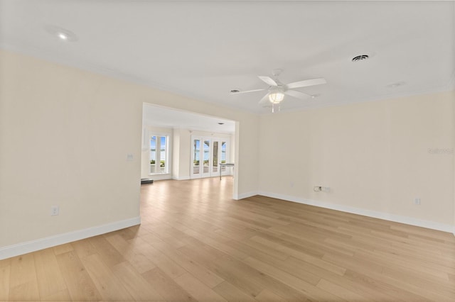 2401 Riverview Blvd, Bradenton, FL 34205 - empty room with light wood-style floors, a ceiling fan, and crown molding