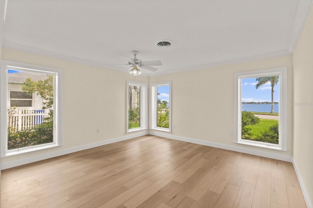 2401 Riverview Blvd, Bradenton, FL 34205 - empty room with ceiling fan, light wood-style floors, and a water view