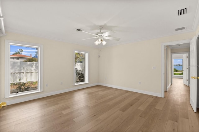 2401 Riverview Blvd, Bradenton, FL 34205 - unfurnished room featuring plenty of natural light, ceiling fan, light wood-style flooring, and crown molding