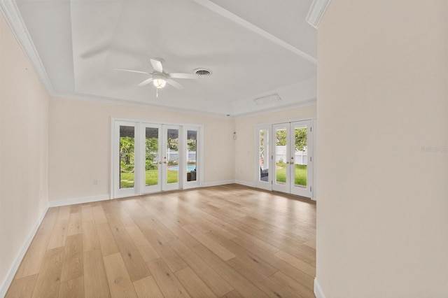 2401 Riverview Blvd, Bradenton, FL 34205 - unfurnished room featuring french doors, ceiling fan, light wood-style floors, ornamental molding, and a raised ceiling