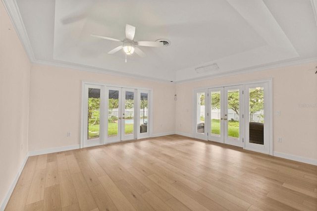 2401 Riverview Blvd, Bradenton, FL 34205 - empty room with french doors, a tray ceiling, plenty of natural light, ceiling fan, and crown molding