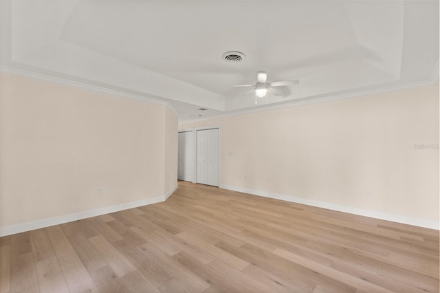 2401 Riverview Blvd, Bradenton, FL 34205 - spare room with a tray ceiling, a ceiling fan, and light wood finished floors