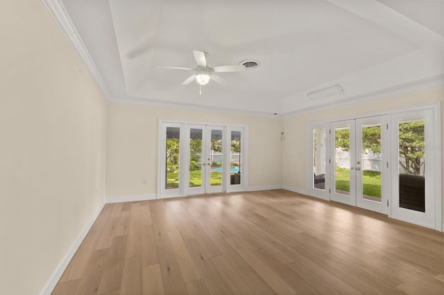 2401 Riverview Blvd, Bradenton, FL 34205 - spare room with french doors, a tray ceiling, ceiling fan, light wood finished floors, and ornamental molding