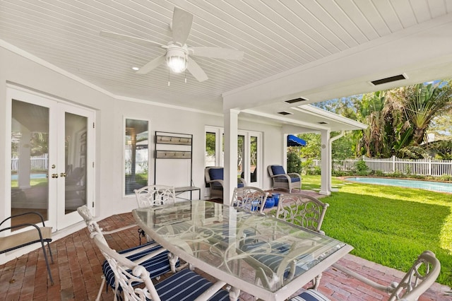 2401 Riverview Blvd, Bradenton, FL 34205 - sunroom / solarium with french doors, outdoor dining space, and a ceiling fan