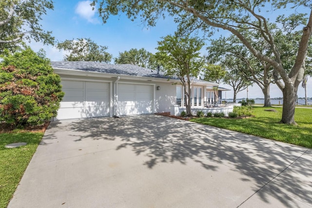2401 Riverview Blvd, Bradenton, FL 34205 - ranch-style home featuring concrete driveway, a garage, a front yard, and stucco siding