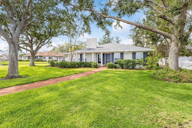 2401 Riverview Blvd, Bradenton, FL 34205 - ranch-style house featuring a front lawn, stucco siding, and a chimney