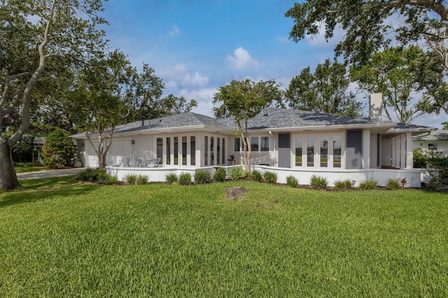 2401 Riverview Blvd, Bradenton, FL 34205 - rear view of property featuring an attached garage, a yard, and driveway