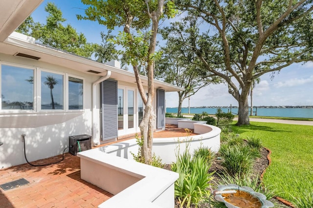 2401 Riverview Blvd, Bradenton, FL 34205 - view of patio featuring french doors and a water view