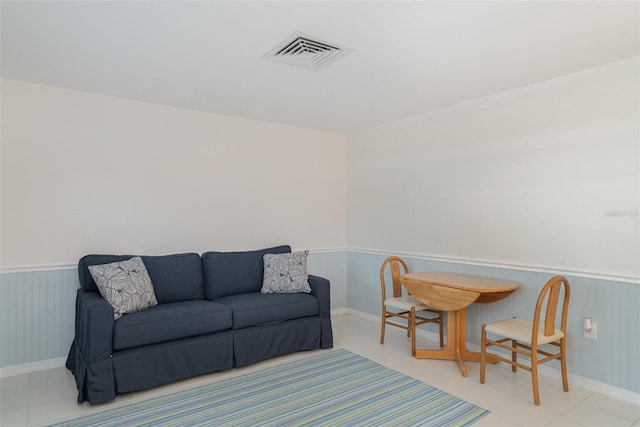 1400 1st Ave W Unit 103, Bradenton, FL 34205 - living room featuring wainscoting and light tile patterned floors
