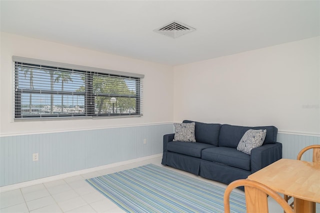 1400 1st Ave W Unit 103, Bradenton, FL 34205 - living area featuring a wainscoted wall and baseboards
