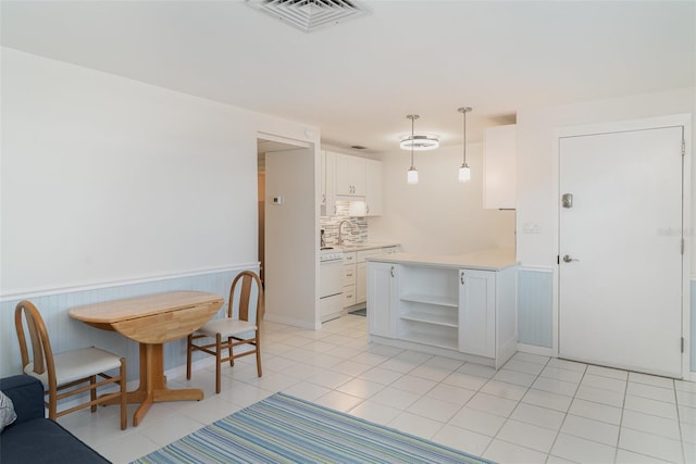 1400 1st Ave W Unit 103, Bradenton, FL 34205 - dining space with wainscoting and light tile patterned floors