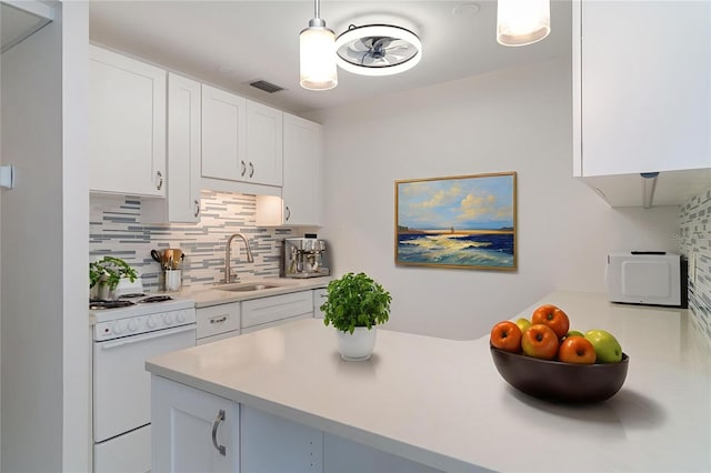 1400 1st Ave W Unit 103, Bradenton, FL 34205 - kitchen featuring tasteful backsplash, light countertops, electric stove, and white cabinets