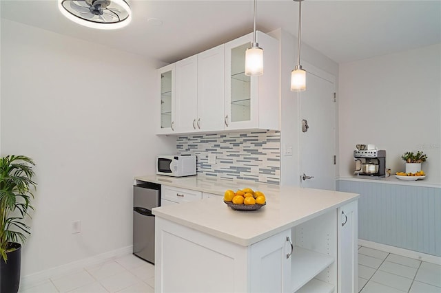 1400 1st Ave W Unit 103, Bradenton, FL 34205 - kitchen with open shelves, tasteful backsplash, light countertops, fridge, and white cabinets