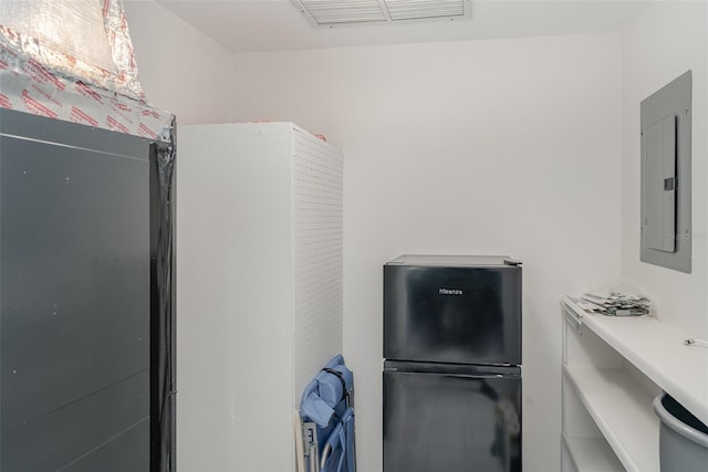 1400 1st Ave W Unit 103, Bradenton, FL 34205 - kitchen with freestanding refrigerator and electric panel