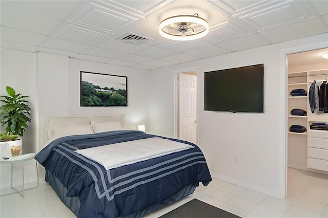 1400 1st Ave W Unit 103, Bradenton, FL 34205 - bedroom featuring a walk in closet and light tile patterned flooring