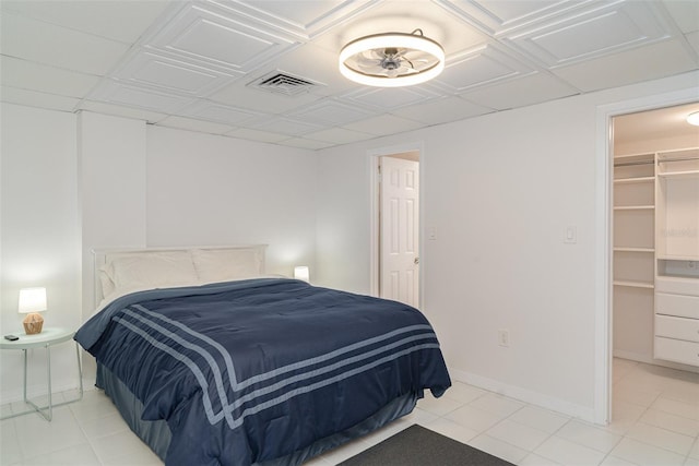 1400 1st Ave W Unit 103, Bradenton, FL 34205 - bedroom with a walk in closet and light tile patterned floors