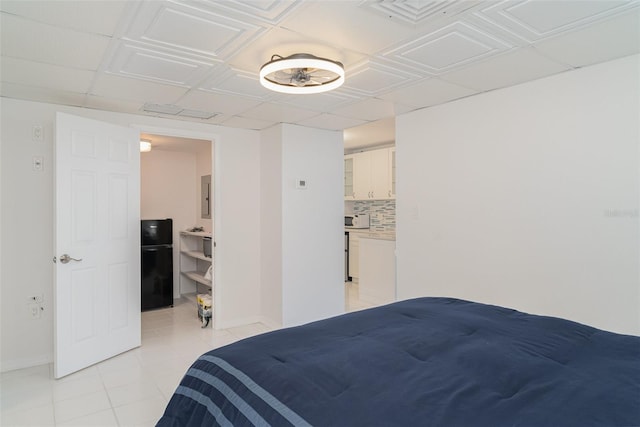 1400 1st Ave W Unit 103, Bradenton, FL 34205 - bedroom with light tile patterned flooring and freestanding refrigerator