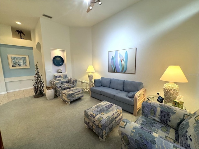 8616 15th Ave NW, Bradenton, FL 34209 - carpeted living area with ceiling fan, tile patterned floors, and arched walkways