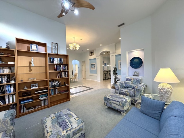 8616 15th Ave NW, Bradenton, FL 34209 - carpeted living area with arched walkways, ceiling fan, and a chandelier