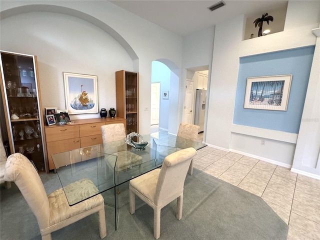 8616 15th Ave NW, Bradenton, FL 34209 - dining area featuring arched walkways and light tile patterned floors