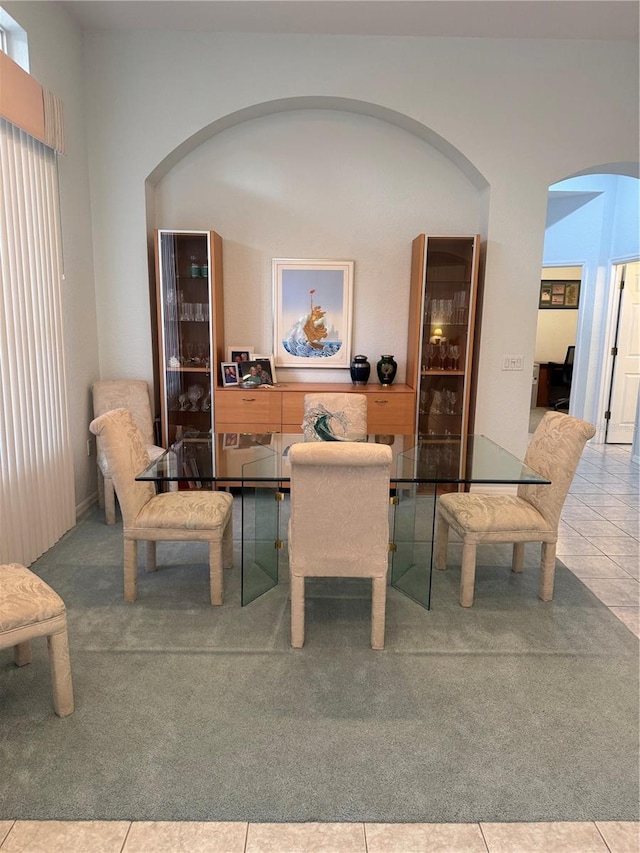 8616 15th Ave NW, Bradenton, FL 34209 - carpeted living area with arched walkways and tile patterned flooring