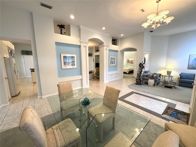 8616 15th Ave NW, Bradenton, FL 34209 - living area featuring arched walkways, decorative columns, light tile patterned floors, a chandelier, and recessed lighting