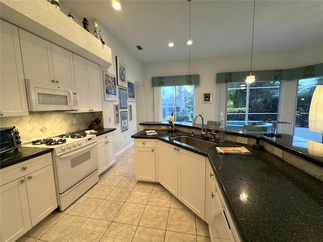 8616 15th Ave NW, Bradenton, FL 34209 - kitchen with white appliances, tasteful backsplash, light tile patterned floors, pendant lighting, and recessed lighting