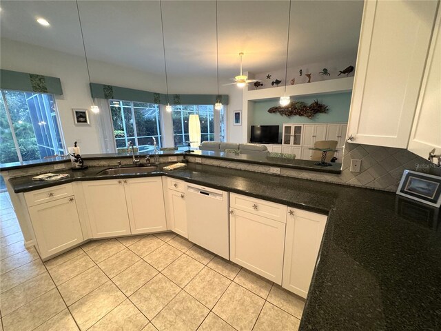 8616 15th Ave NW, Bradenton, FL 34209 - kitchen with dishwasher, light tile patterned floors, pendant lighting, backsplash, and white cabinets